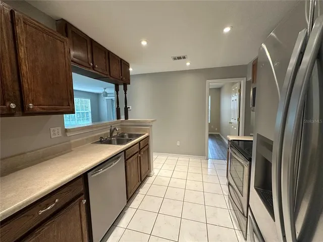 a kitchen with a sink and a stove top oven