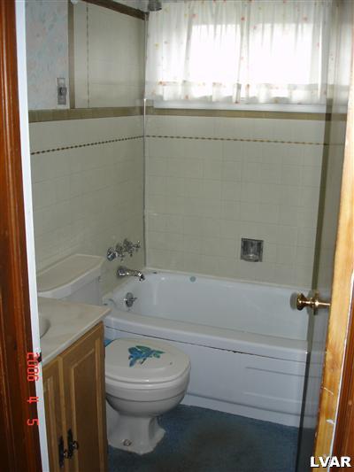 353 West Street Bath, PA 18014 - Photo 5 of 9 a bathroom with a sink a toilet and shower
