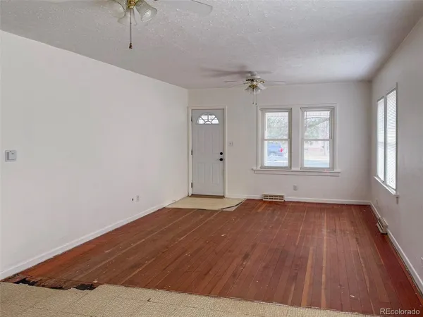 wooden floor in an empty room with a window