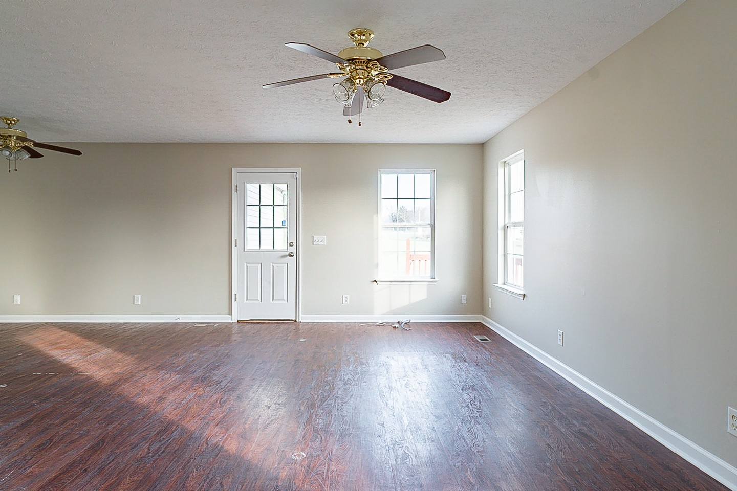 85 Blue Well Road Lebanon, TN 37090 - Photo 11 of 27 an empty room with wooden floor and windows