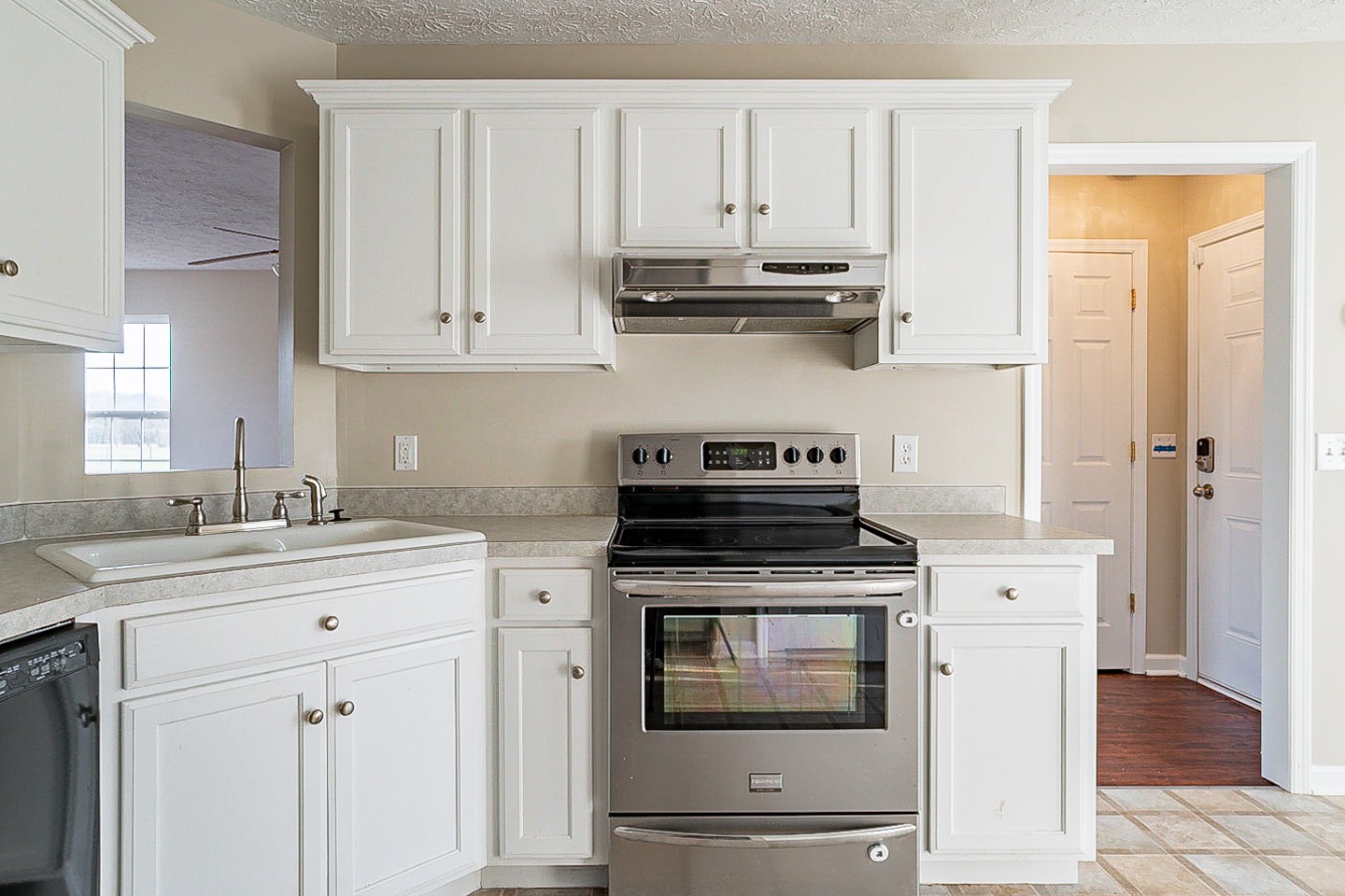 85 Blue Well Road Lebanon, TN 37090 - Photo 8 of 27 a kitchen with stainless steel appliances granite countertop white cabinets stove a sink and dishwasher