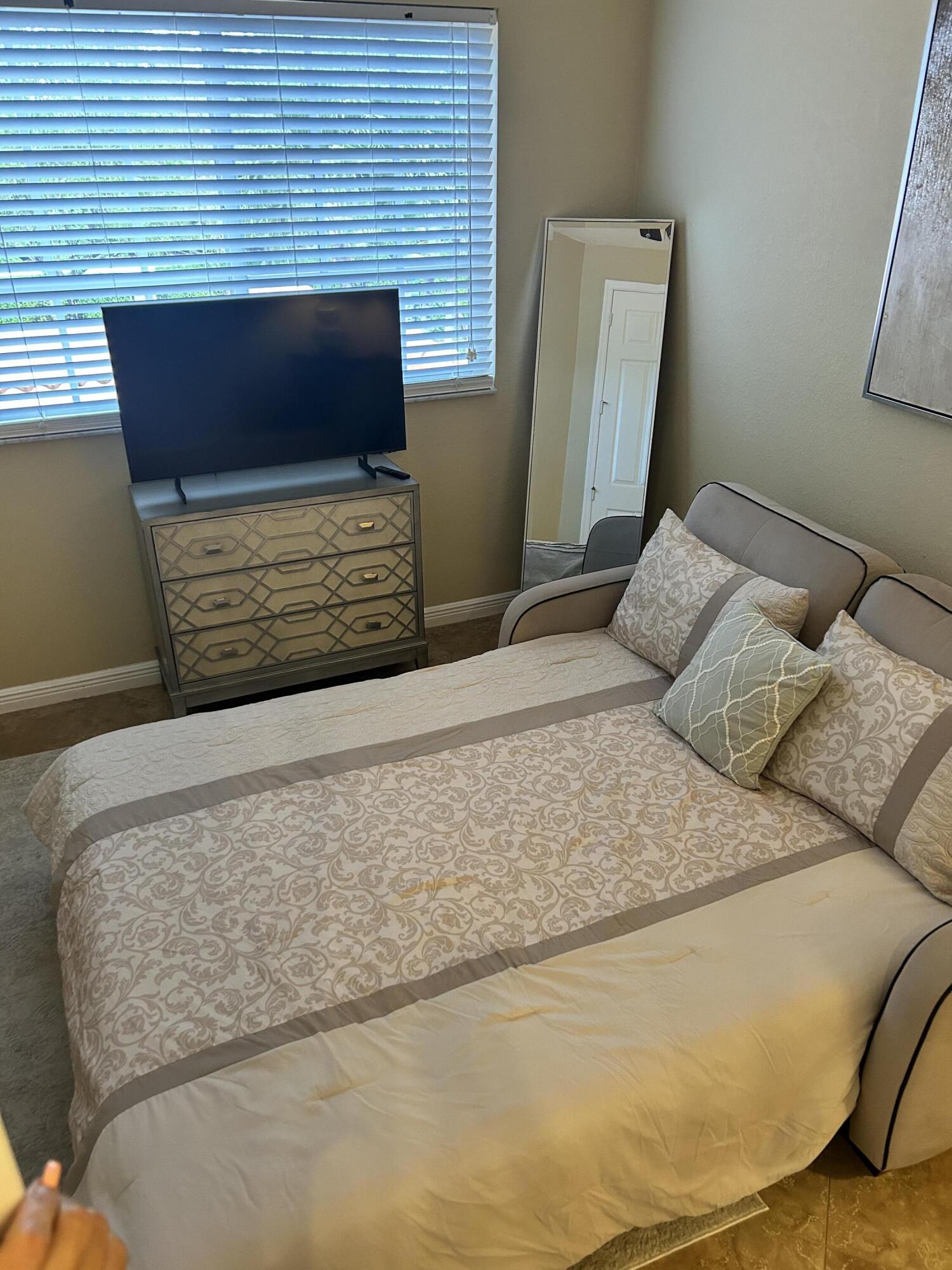 16075 Sims Road, Unit 203 Delray Beach, FL 33484 - Photo 10 of 20 a bedroom with a bed and a flat screen tv