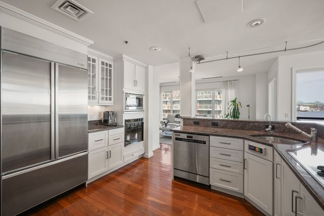 a large kitchen with cabinets and stainless steel appliances