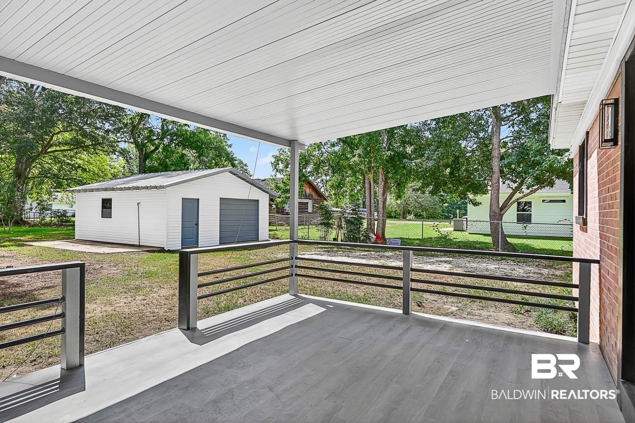 101 Terry Avenue Brewton, AL 36426 - Photo 10 of 48 View of patio / terrace featuring an outdoor structure and a detached garage