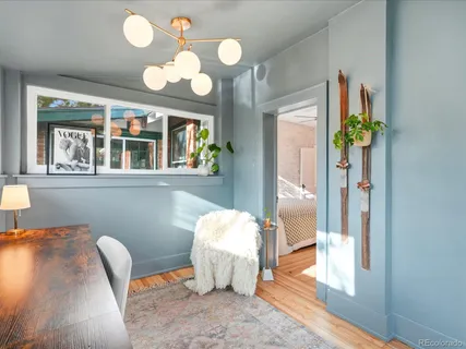 a view of a dining room with furniture and a chandelier