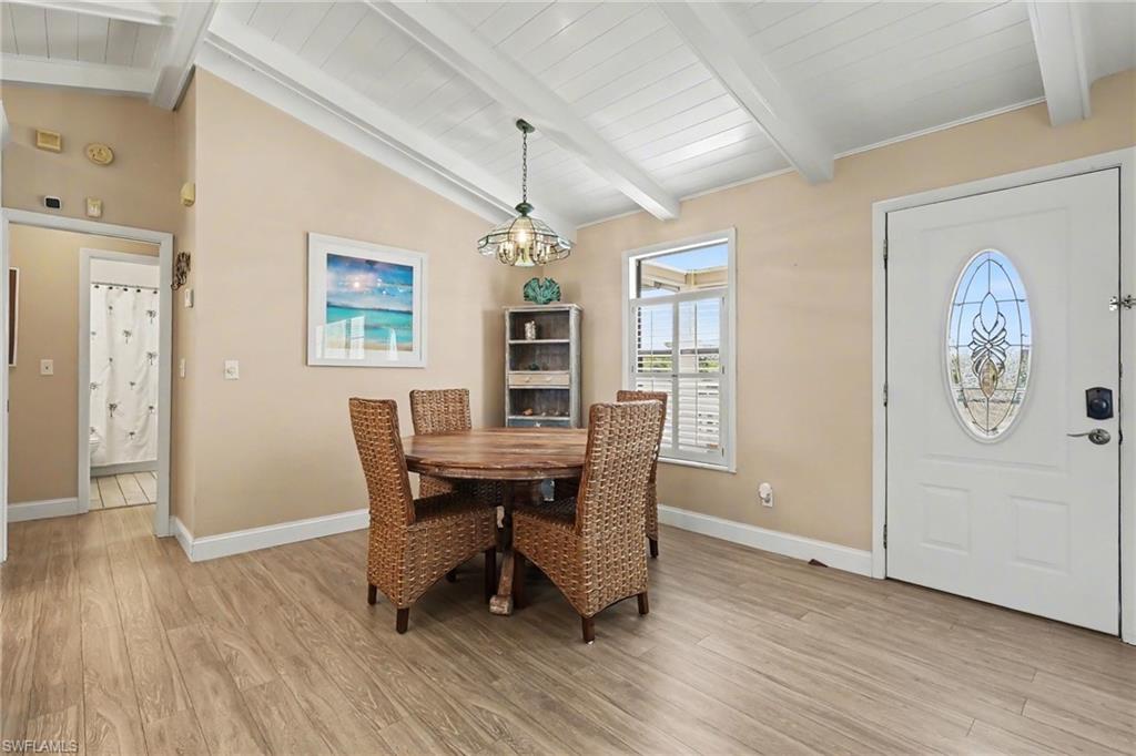 4838 Gary Road Bonita Springs, FL 34134 - Photo 13 of 29 a view of a dining room with furniture window and wooden floor