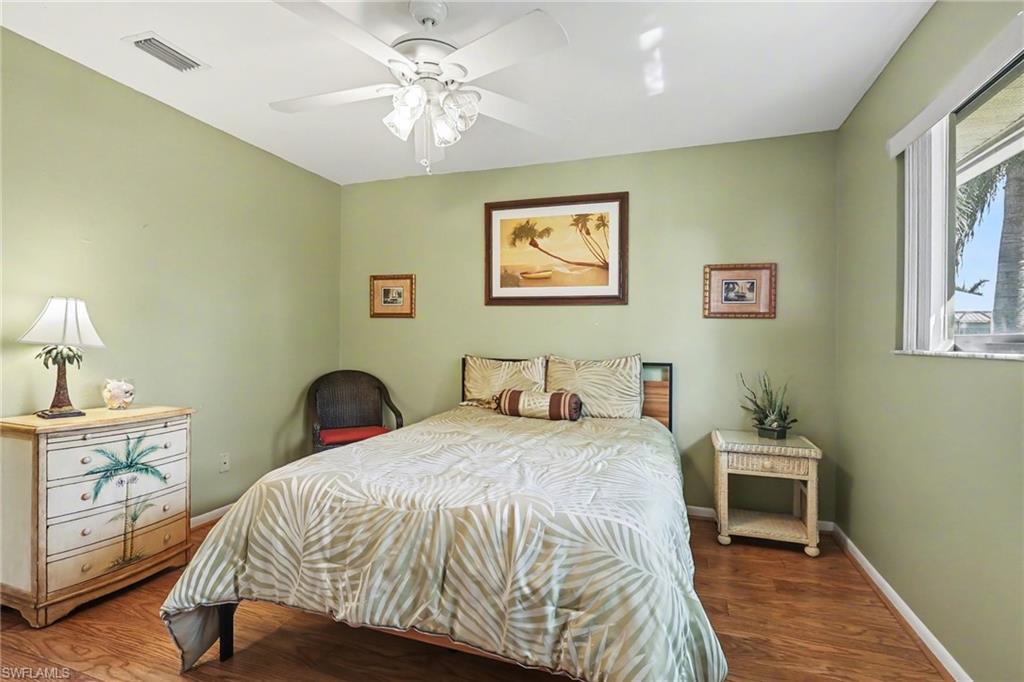 4838 Gary Road Bonita Springs, FL 34134 - Photo 20 of 29 a bedroom with a bed and a chandelier