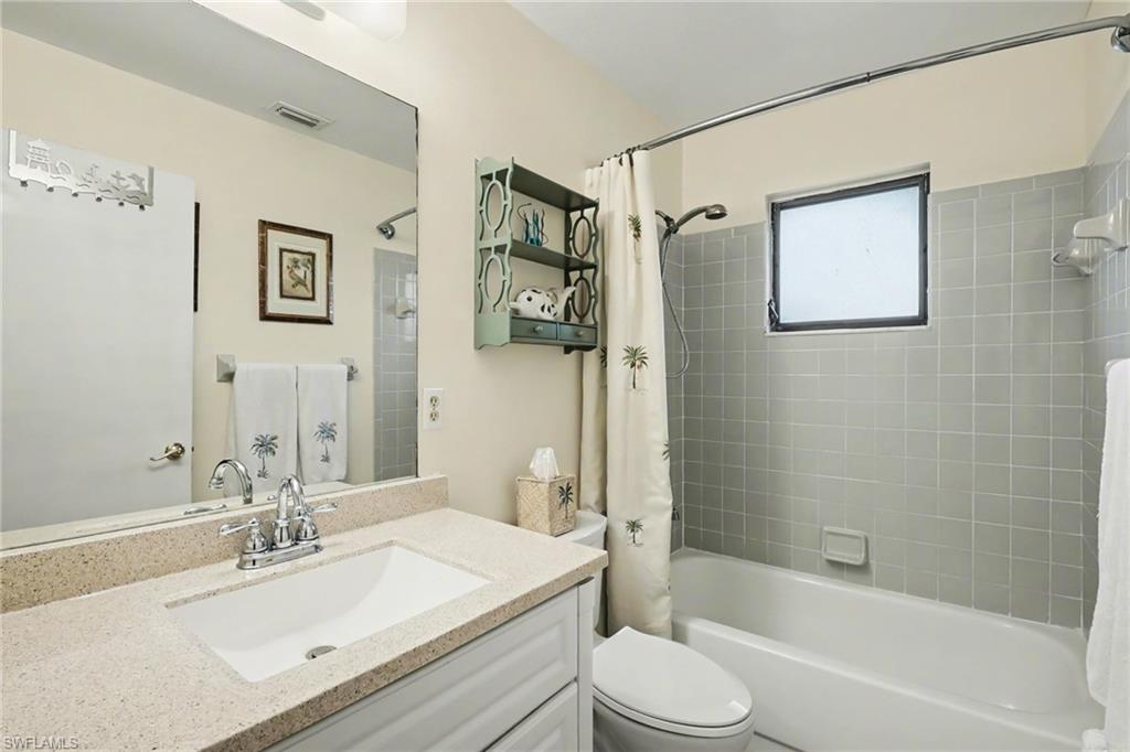 4838 Gary Road Bonita Springs, FL 34134 - Photo 21 of 29 a bathroom with a bathtub shower sink vanity mirror and toilet