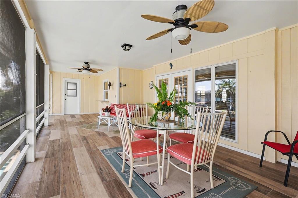 4838 Gary Road Bonita Springs, FL 34134 - Photo 24 of 29 a view of a dining room with furniture and a chandelier fan