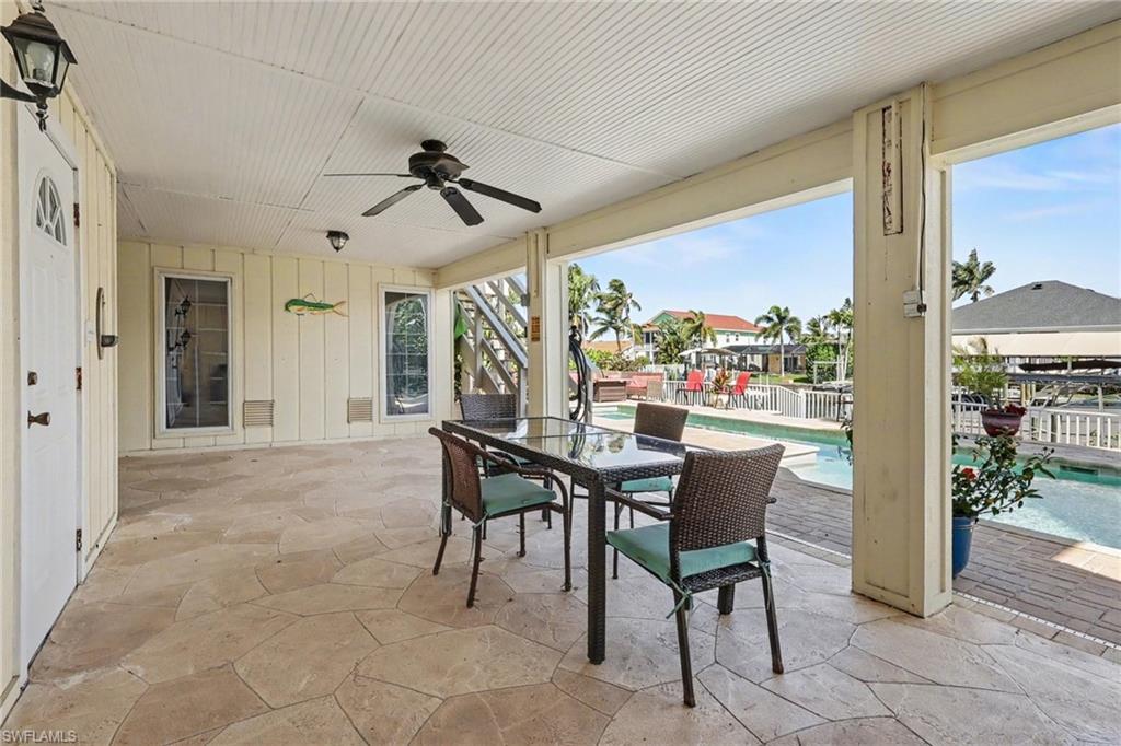 4838 Gary Road Bonita Springs, FL 34134 - Photo 25 of 29 a dining room with furniture and a floor to ceiling window