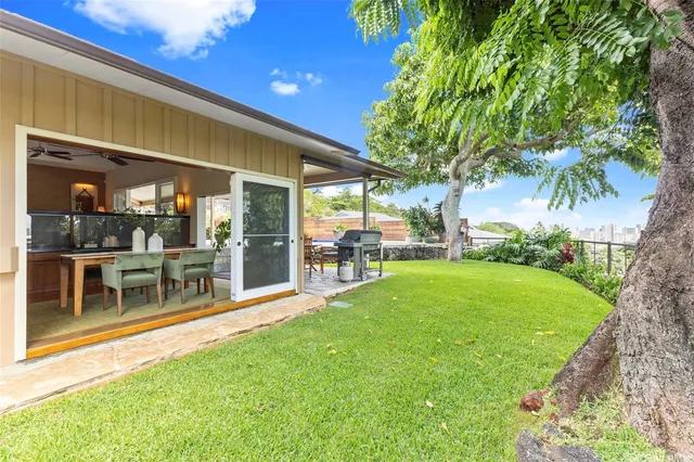 a view of a house with a backyard porch and sitting area