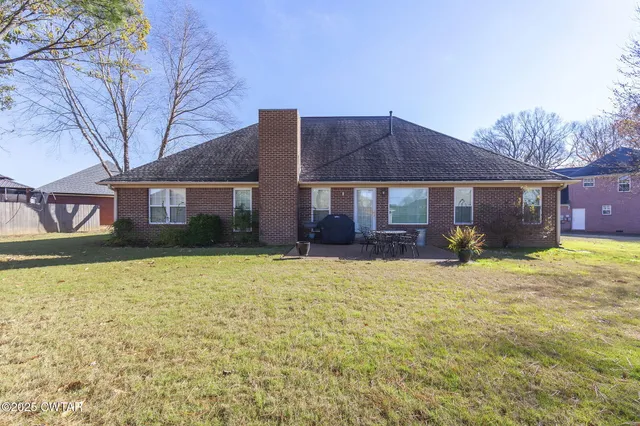a view of house with yard