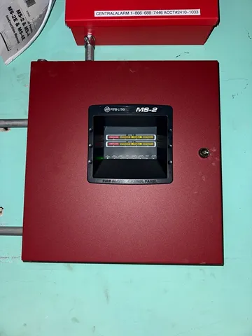 a view of an empty room with a fireplace and wooden floor