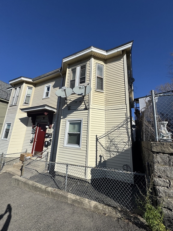 28 Grand Street Lowell, MA 01851 - Photo 22 of 23 a front view of a house with garage