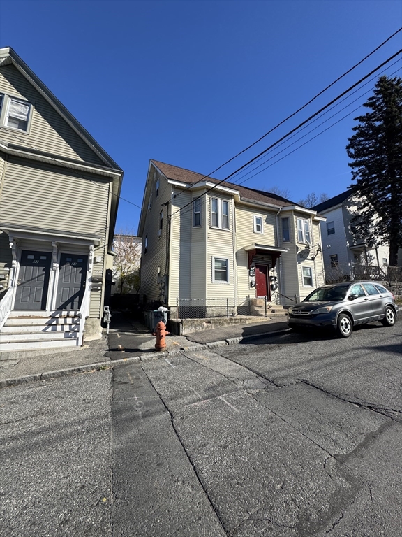 28 Grand Street Lowell, MA 01851 - Photo 23 of 23 a view of a cars parked in front of a building