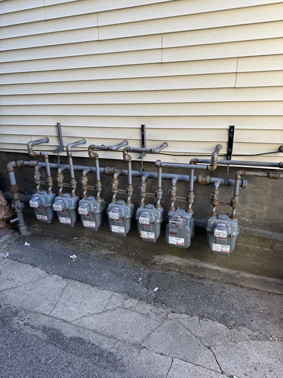 28 Grand Street Lowell, MA 01851 - Photo 4 of 23 a view of a garage with parked cars