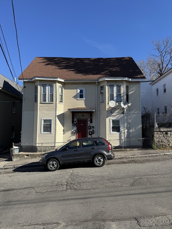 28 Grand Street Lowell, MA 01851 - Photo 5 of 23 a car parked in front of a house
