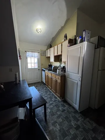 a kitchen with refrigerator and window