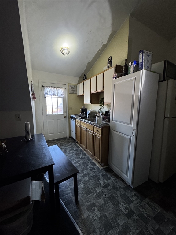 28 Grand Street Lowell, MA 01851 - Photo 7 of 23 a kitchen with refrigerator and window
