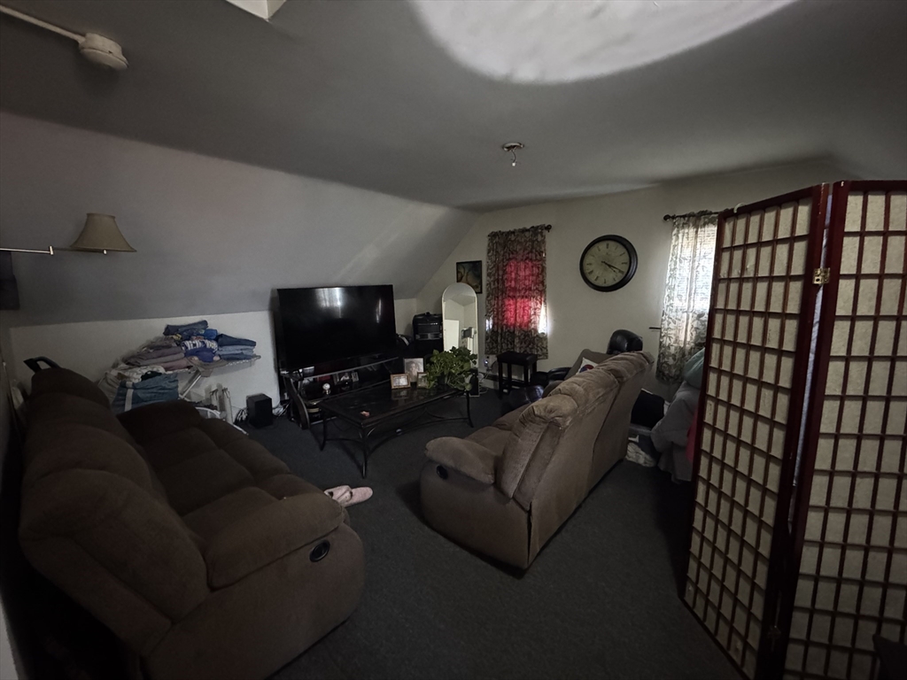 28 Grand Street Lowell, MA 01851 - Photo 8 of 23 a living room with furniture and a flat screen tv