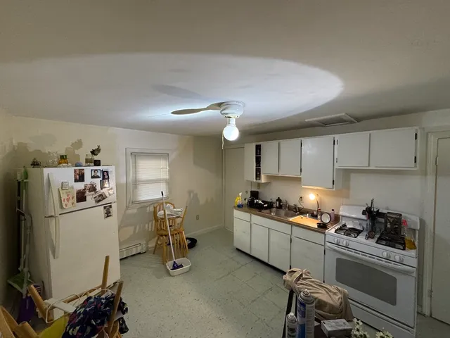 a kitchen with refrigerator and cabinets