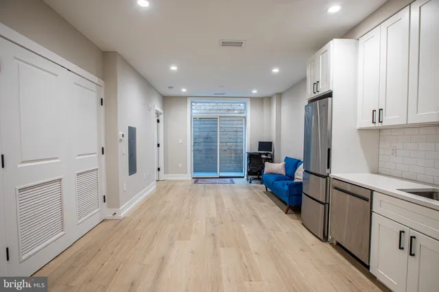 a kitchen with stainless steel appliances a refrigerator sink and cabinets