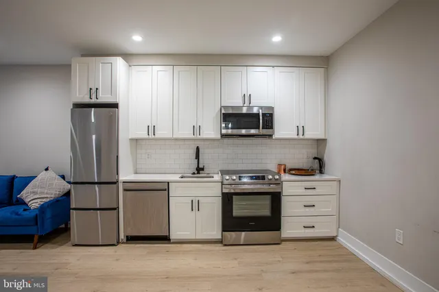 a kitchen with stainless steel appliances a sink and a refrigerator