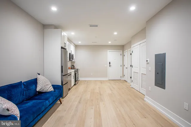 a large room with a couch and a refrigerator