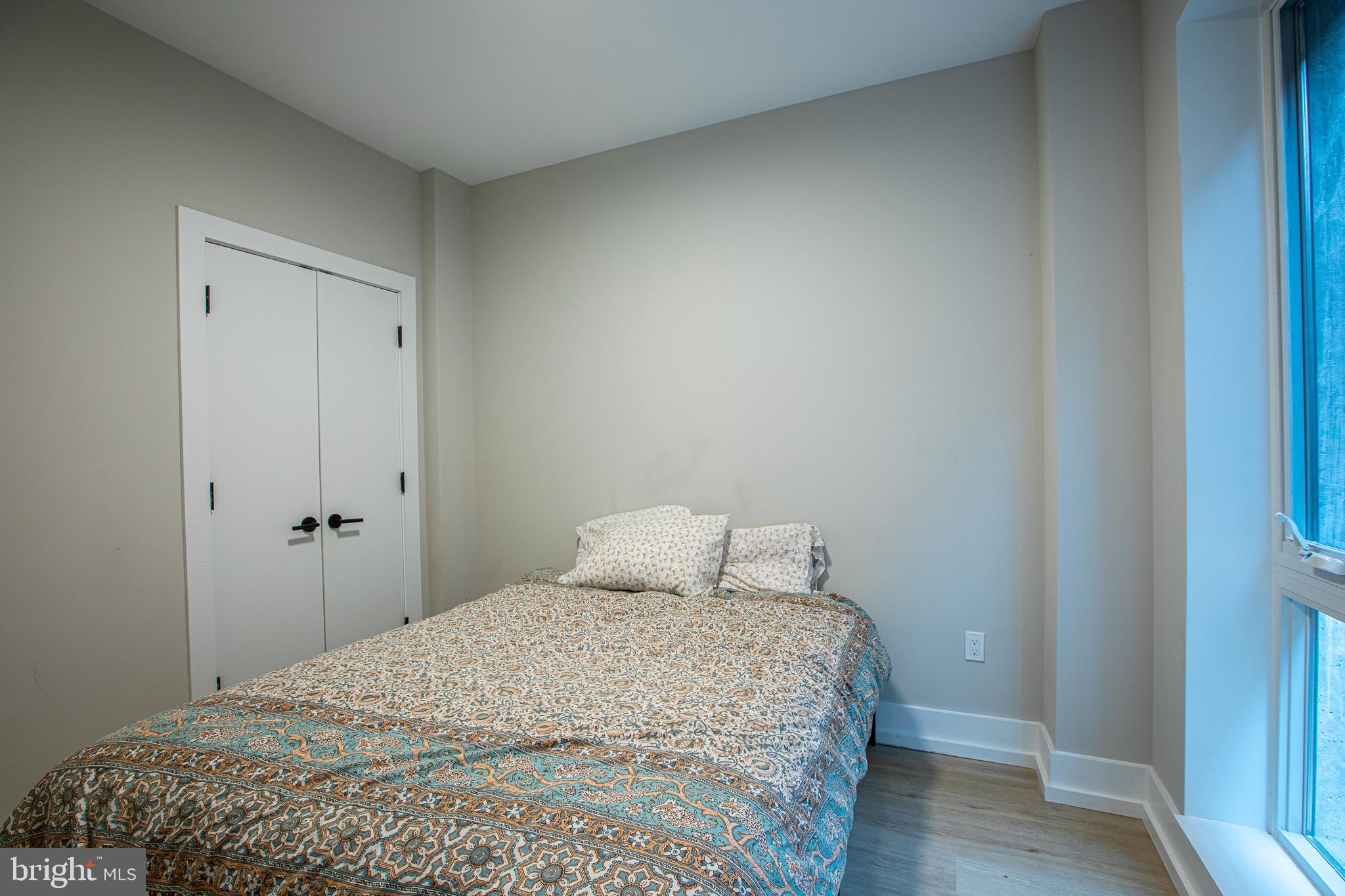 1016 17th Place Northeast, Unit 8 Washington, DC 20002 - Photo 17 of 21 a bedroom with a bed and wooden floor