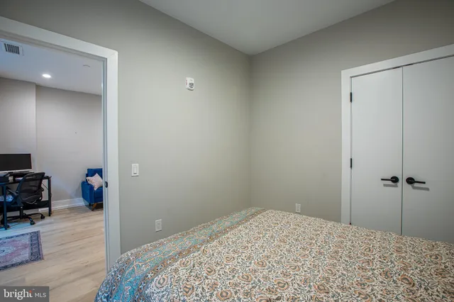 a bedroom with a bed and a dresser