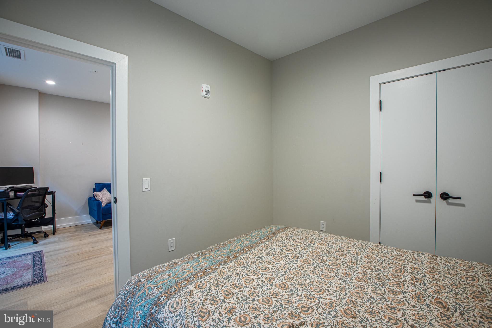1016 17th Place Northeast, Unit 8 Washington, DC 20002 - Photo 18 of 21 a bedroom with a bed and a dresser