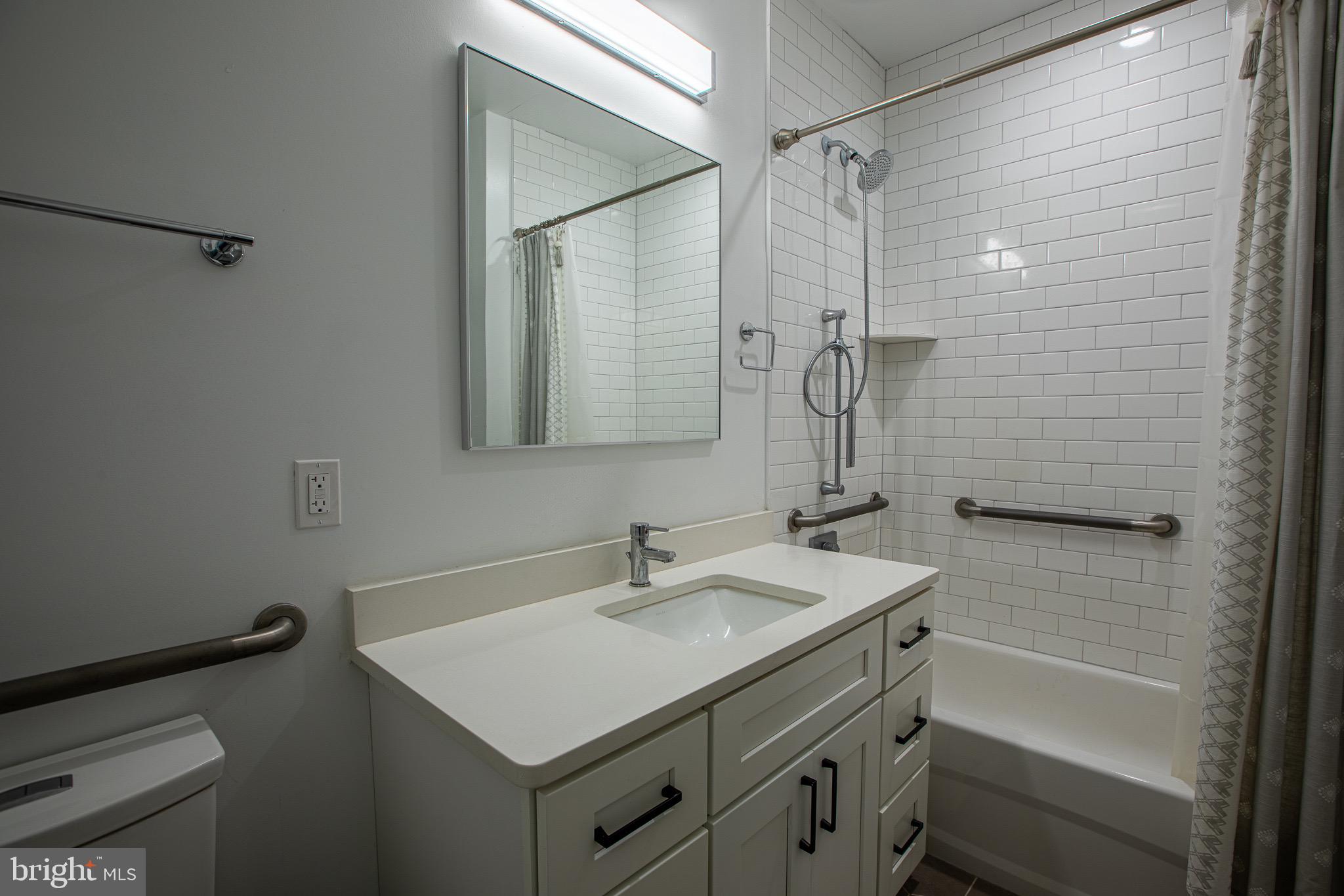 1016 17th Place Northeast, Unit 8 Washington, DC 20002 - Photo 20 of 21 a bathroom with a sink toilet vanity and shower