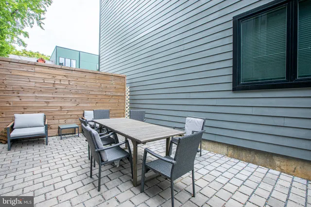 a backyard of a house with a table and chairs