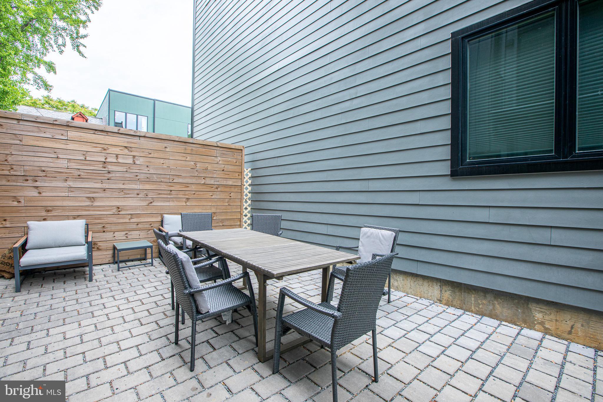 1016 17th Place Northeast, Unit 8 Washington, DC 20002 - Photo 5 of 21 a backyard of a house with a table and chairs