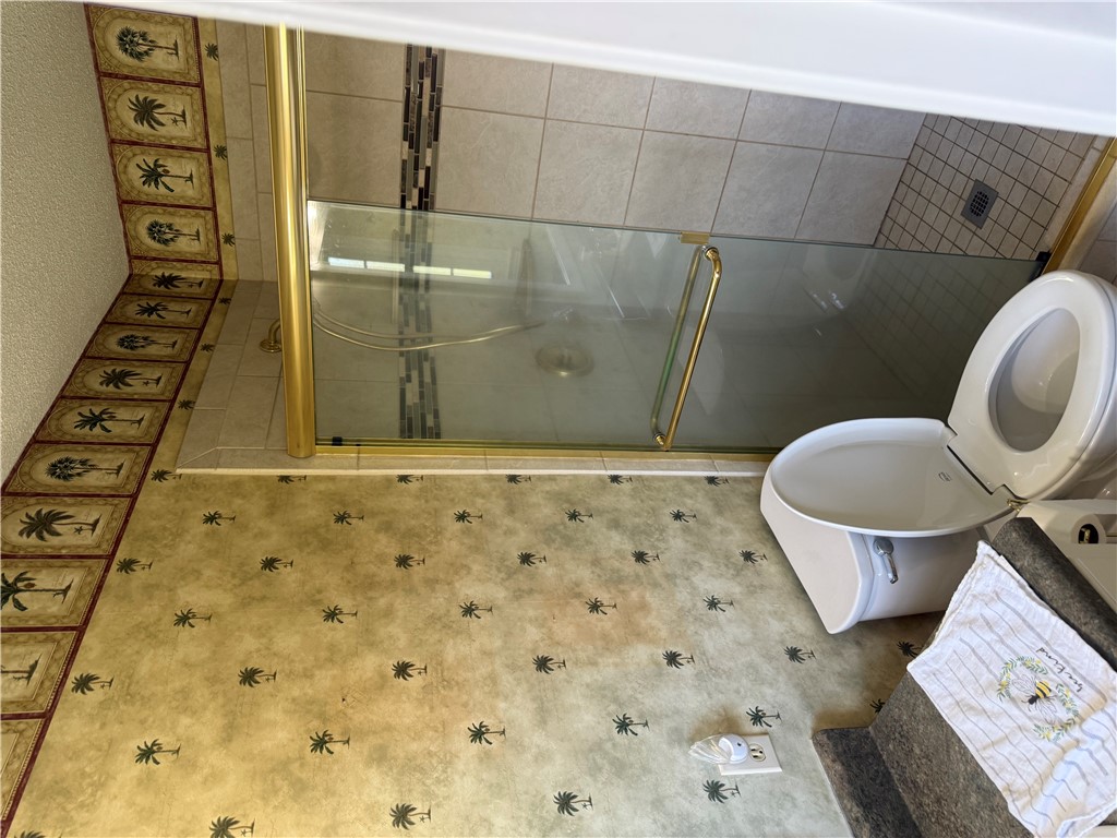 121 Nautical Way Anderson, SC 29625 - Photo 34 of 37 Step into a uniquely tiled primary bathroom featuring a spacious walk-in shower and modern commode.