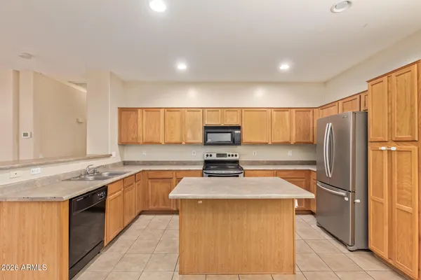 a kitchen with a refrigerator a sink and cabinets