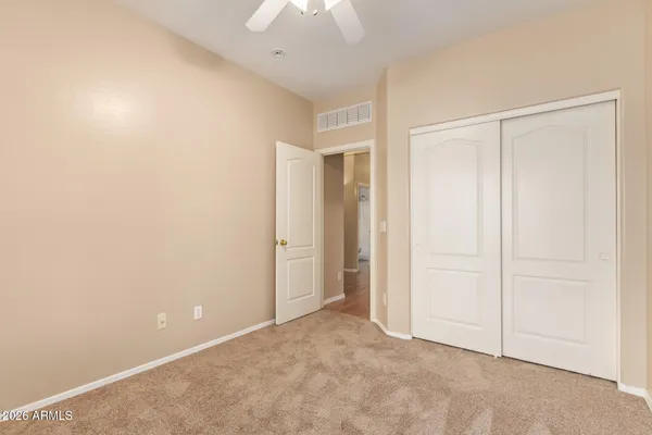 an empty room with a ceiling fan