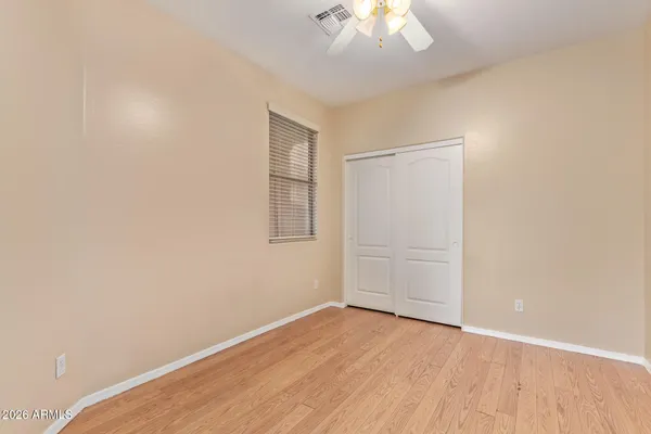 an empty room with a chandelier fan
