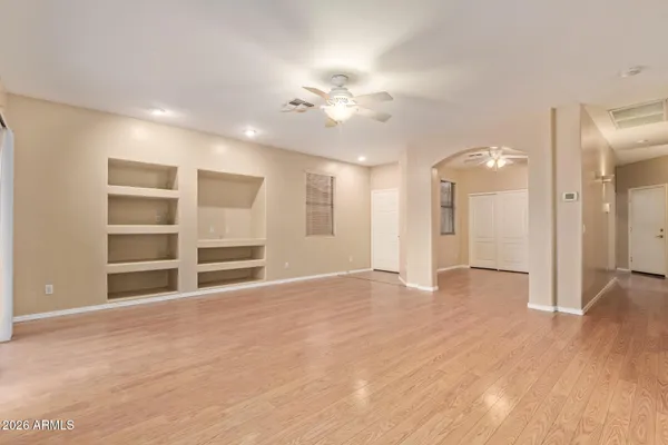 a view of an empty room with a kitchen