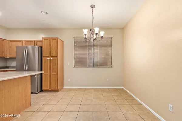 a view of a kitchen with a sink and refrigerator