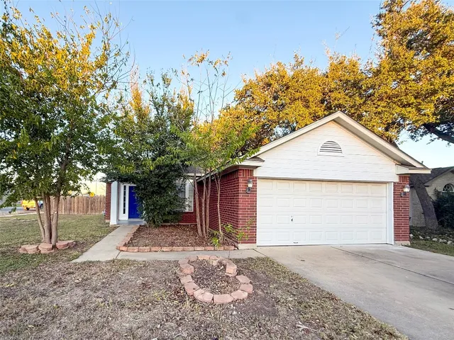 a view of a house with a yard and garage