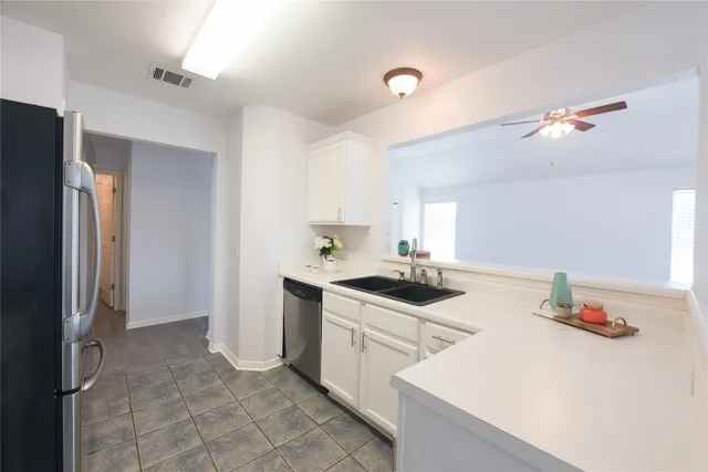 a kitchen with a sink appliances and cabinets