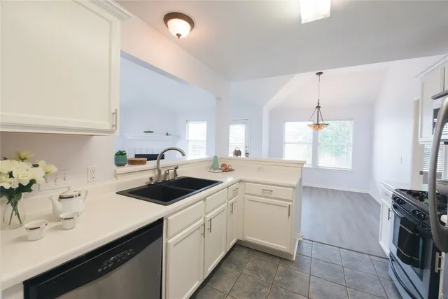 a kitchen with a sink stove and cabinets