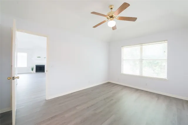 wooden floor in an empty room with a window