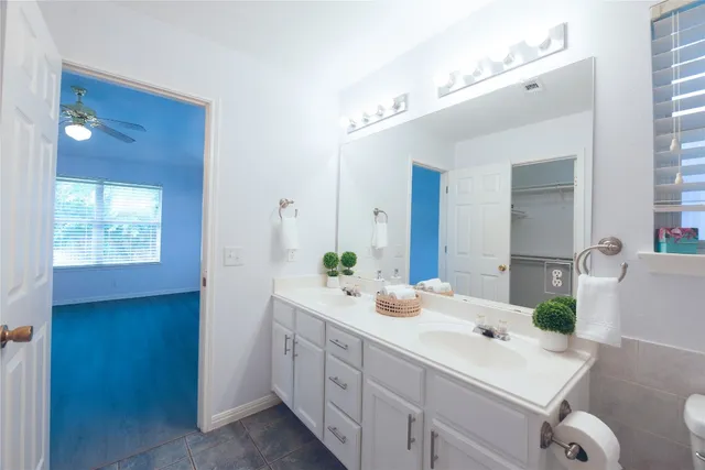 a bathroom with a double vanity sink mirror and shower