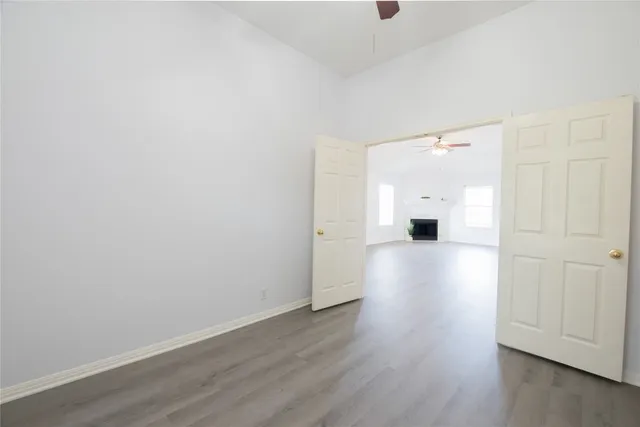a view of empty room with wooden floor