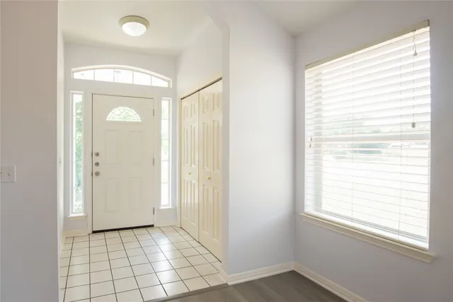 an empty room with windows and closet