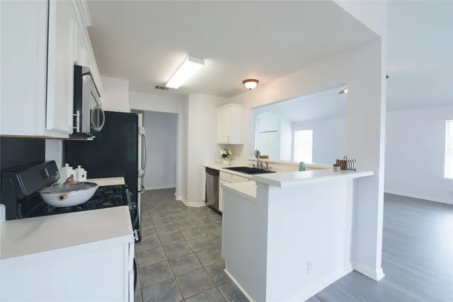 a kitchen with a refrigerator and a sink