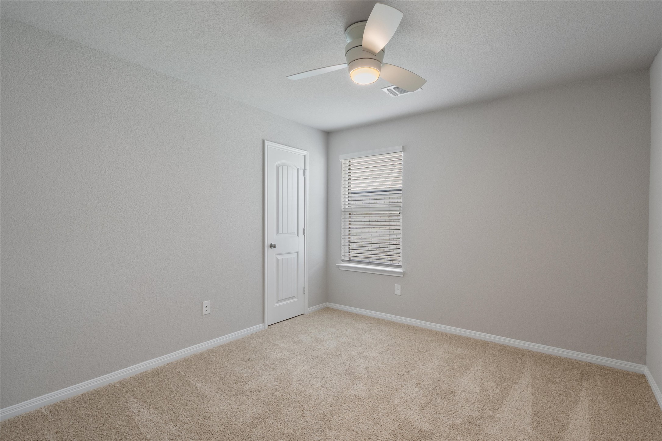 19525 Abigail Fillmore Road Manor, TX 78653 - Photo 25 of 38 A well-proportioned bedroom with neutral carpet and ample natural light.