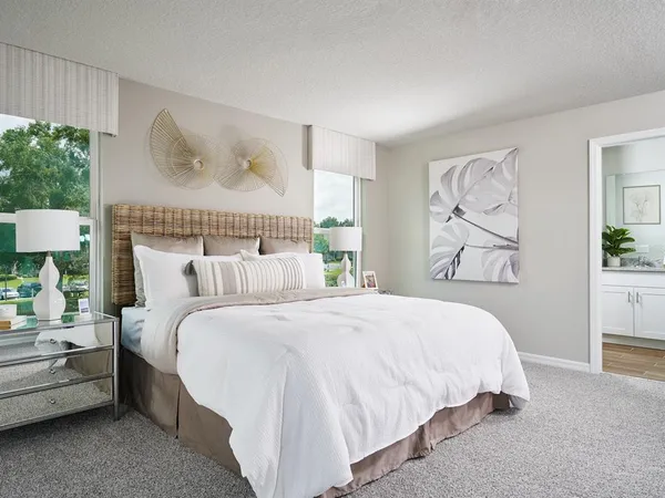 a bedroom with a bed and a painting on the wall